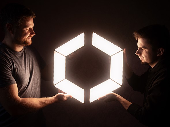 aptolux team holding lights